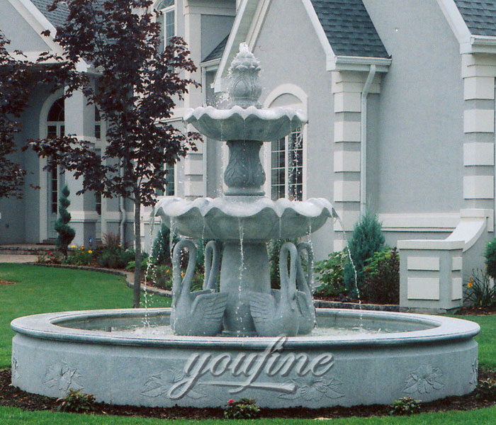 Large tiered hotel water fountain with swan statues outdoor