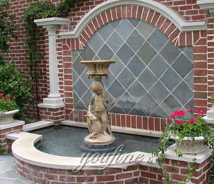 Tiered antique marble water wall fountain with angel and goat statue indoor